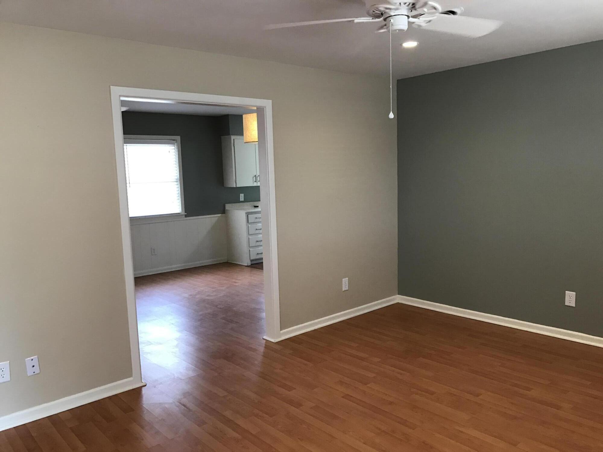4409 27th Street Lubbock, TX 79410 - Photo 16 of 18 a view of a room with wooden floor and a ceiling fan