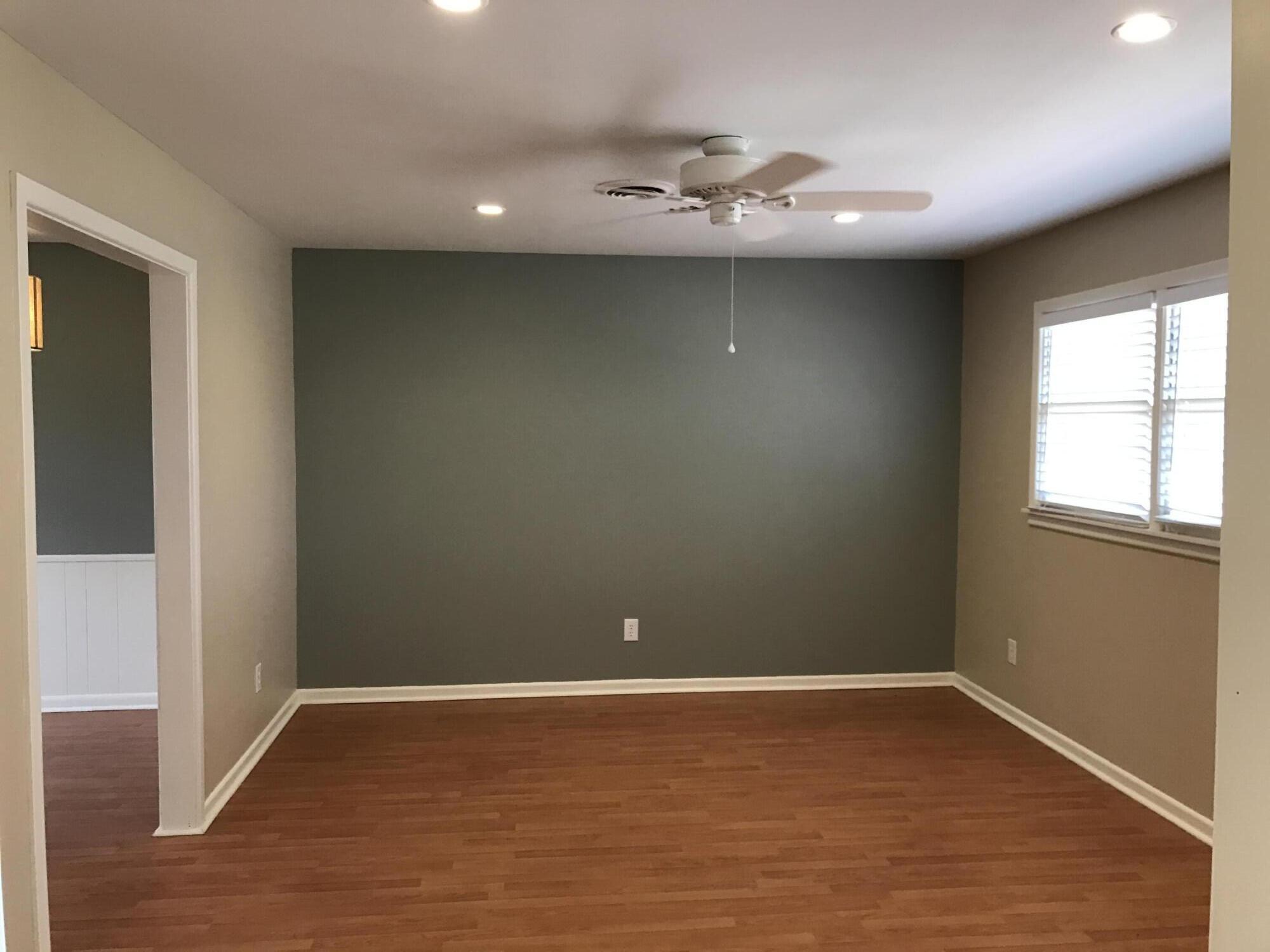 4409 27th Street Lubbock, TX 79410 - Photo 17 of 18 a view of an empty room with wooden floor and a window