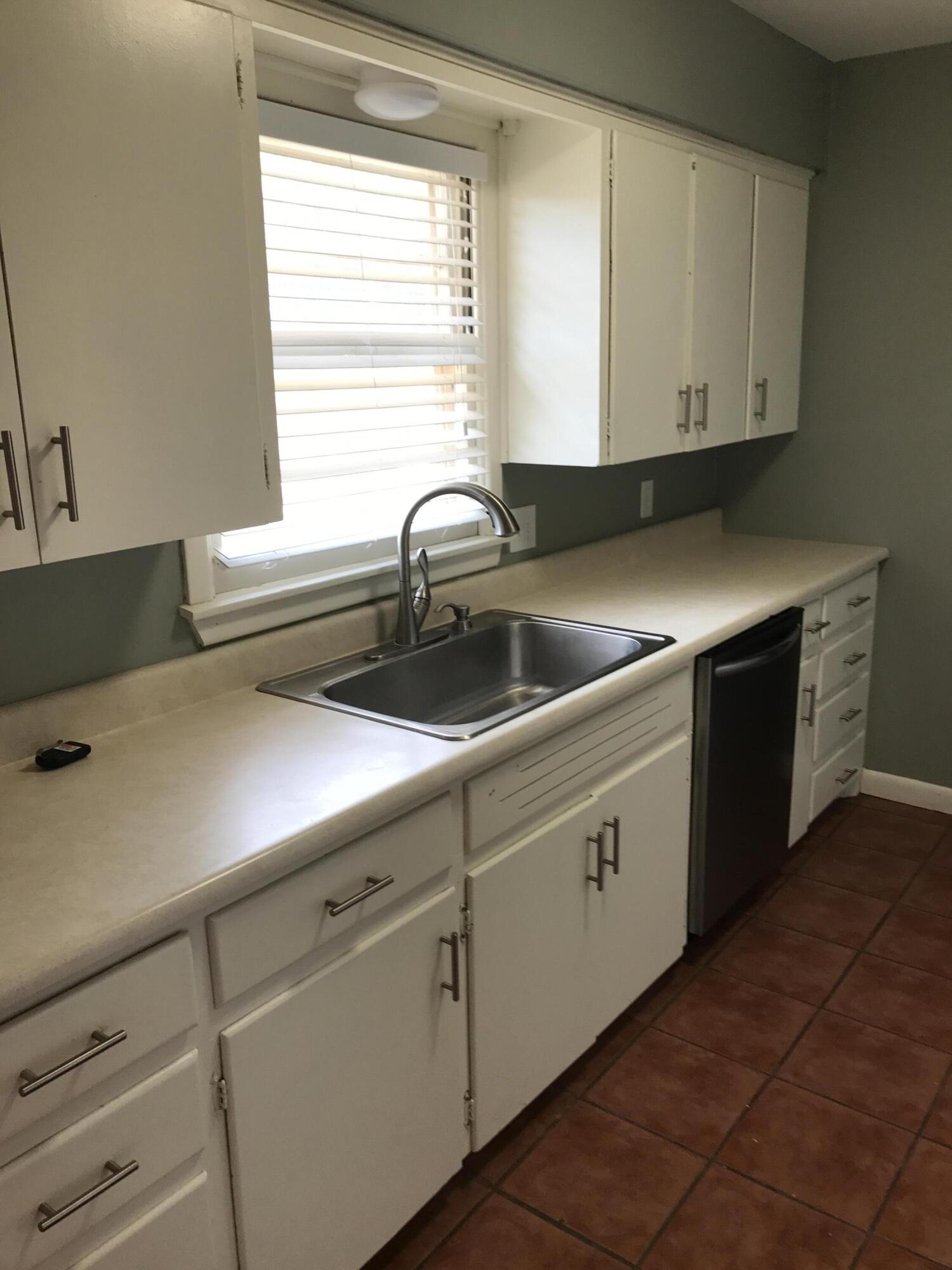 4409 27th Street Lubbock, TX 79410 - Photo 2 of 18 a kitchen with stainless steel appliances white cabinets and a window