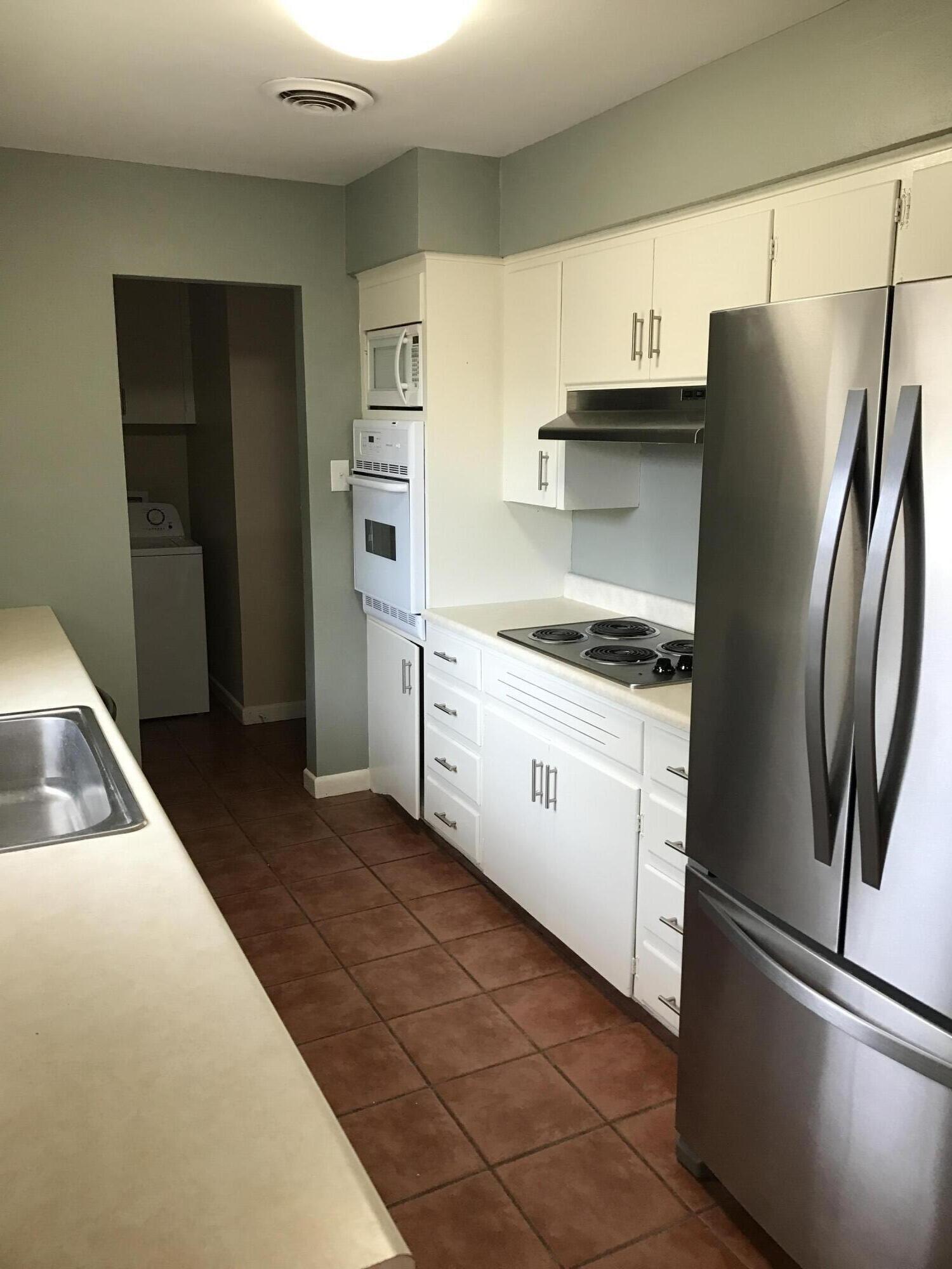 4409 27th Street Lubbock, TX 79410 - Photo 3 of 18 a kitchen with stainless steel appliances cabinets and a refrigerator