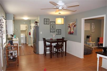 4409 27th Street Lubbock, TX 79410 - Photo 4 of 18 a view of a dining room with furniture and a chandelier fan