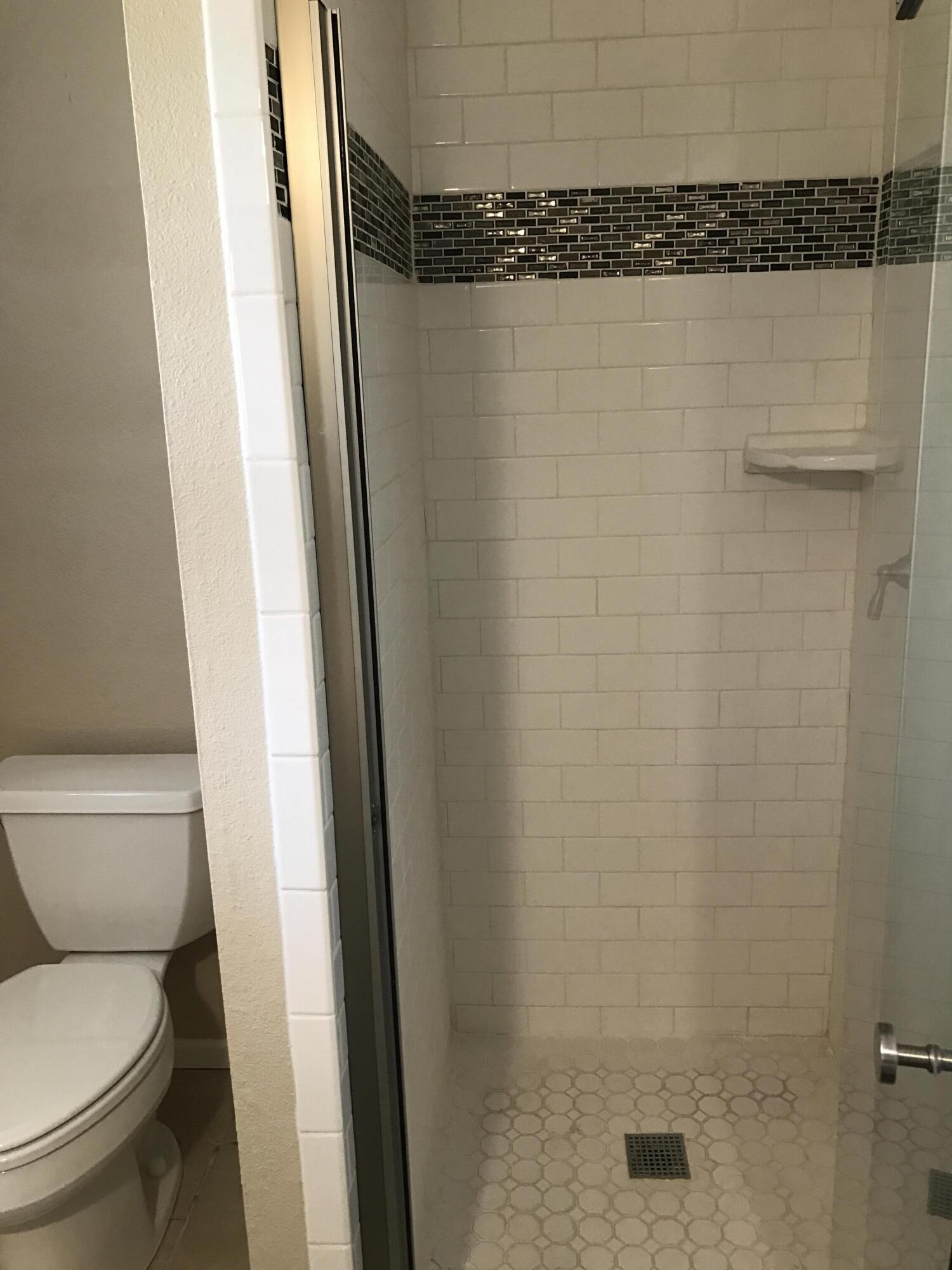 4409 27th Street Lubbock, TX 79410 - Photo 6 of 18 a bathroom with a toilet and a shower