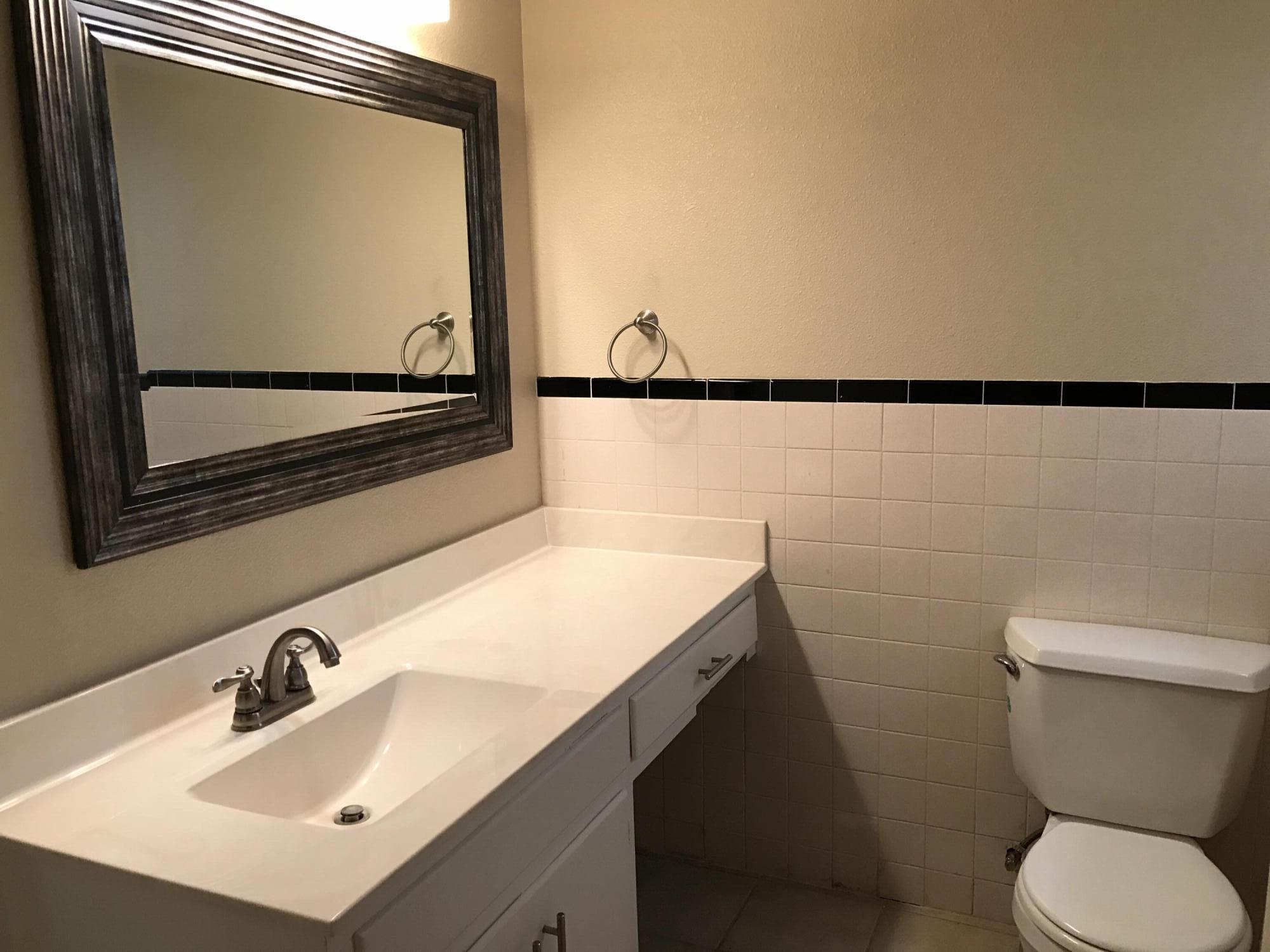 4409 27th Street Lubbock, TX 79410 - Photo 9 of 18 a bathroom with a sink and a mirror