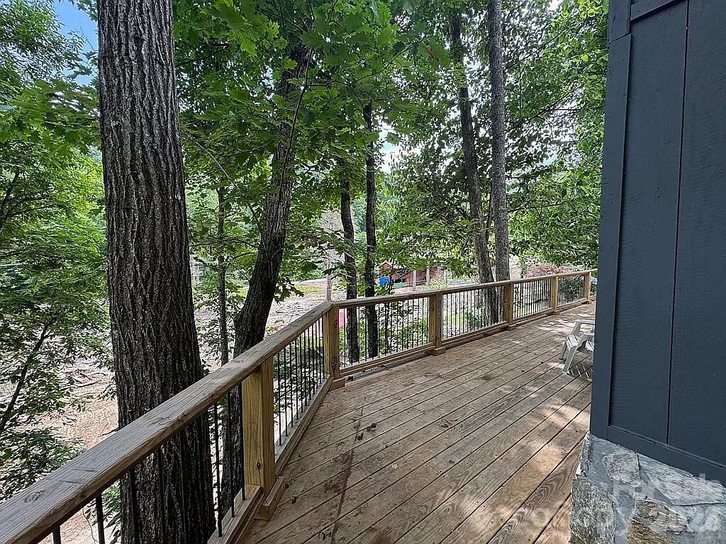 101 Mountain Farm Road Burnsville, NC 28714 - Photo 13 of 32 a view of a wooden deck next to a yard