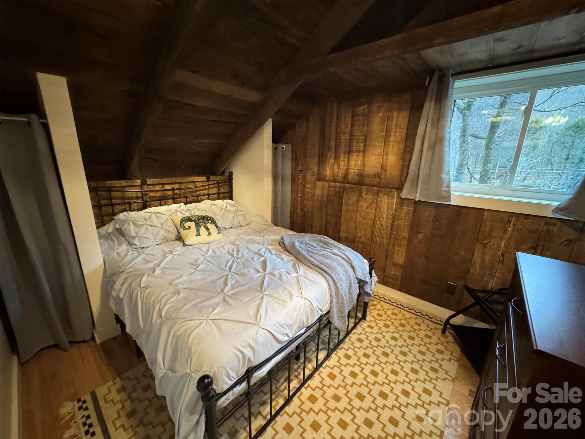 101 Mountain Farm Road Burnsville, NC 28714 - Photo 25 of 32 a bed sitting in a bedroom next to a window