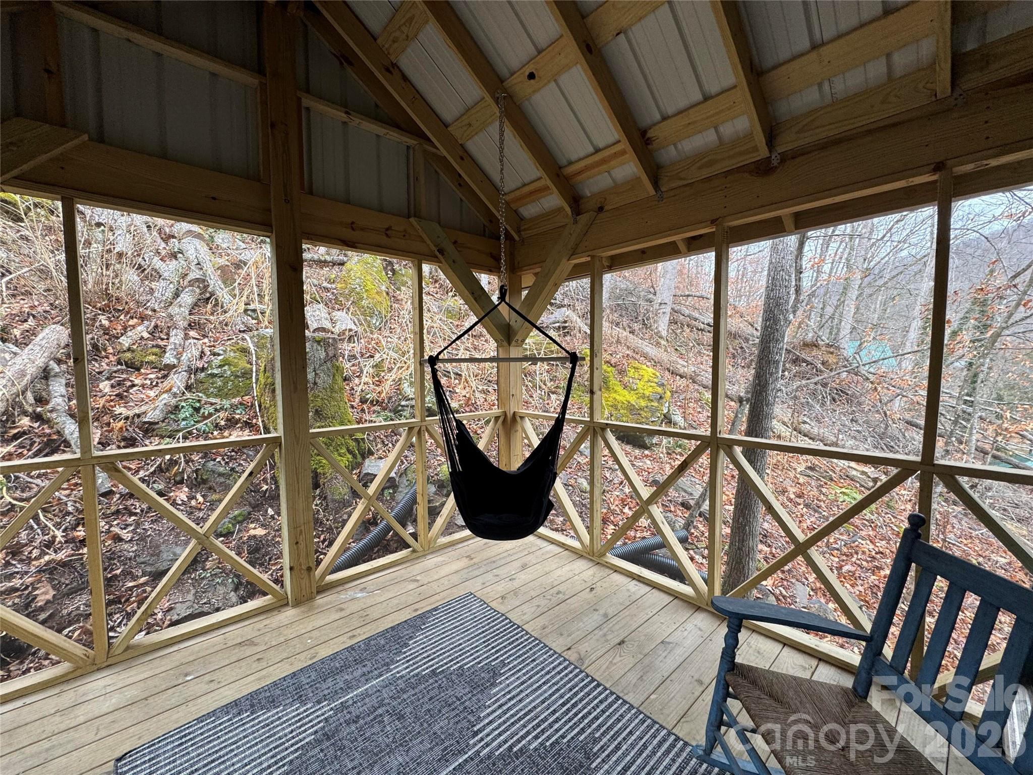 101 Mountain Farm Road Burnsville, NC 28714 - Photo 29 of 32 a view of a chairs and table in the balcony