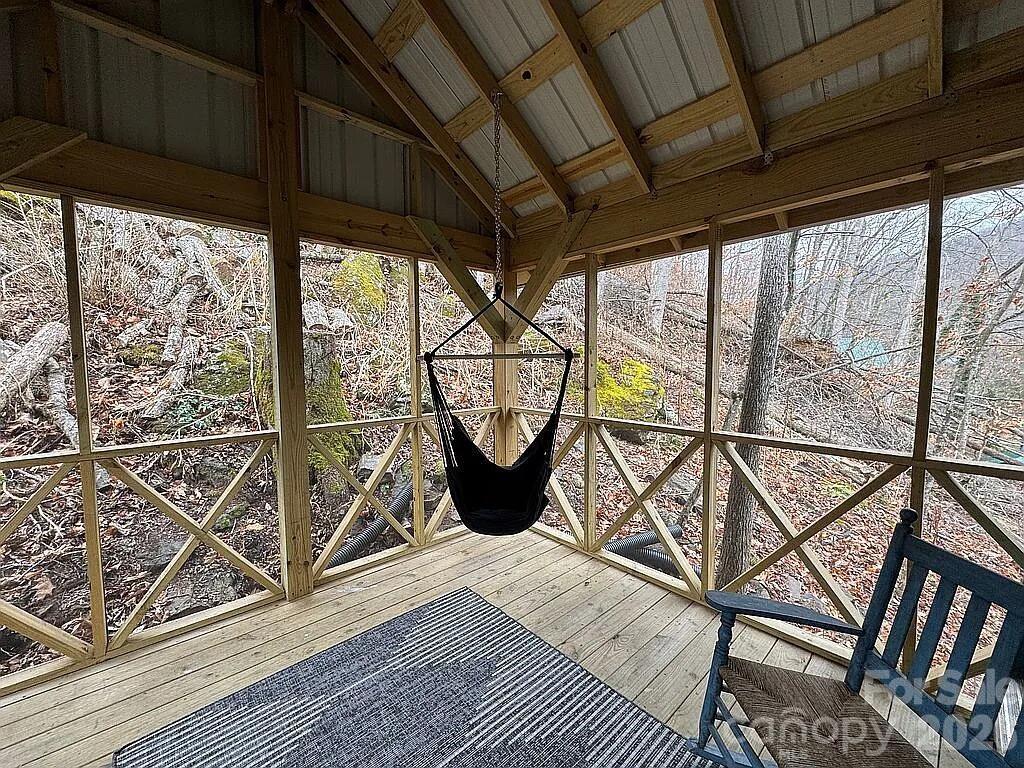 101 Mountain Farm Road Burnsville, NC 28714 - Photo 31 of 32 a view of a chairs and table in the balcony