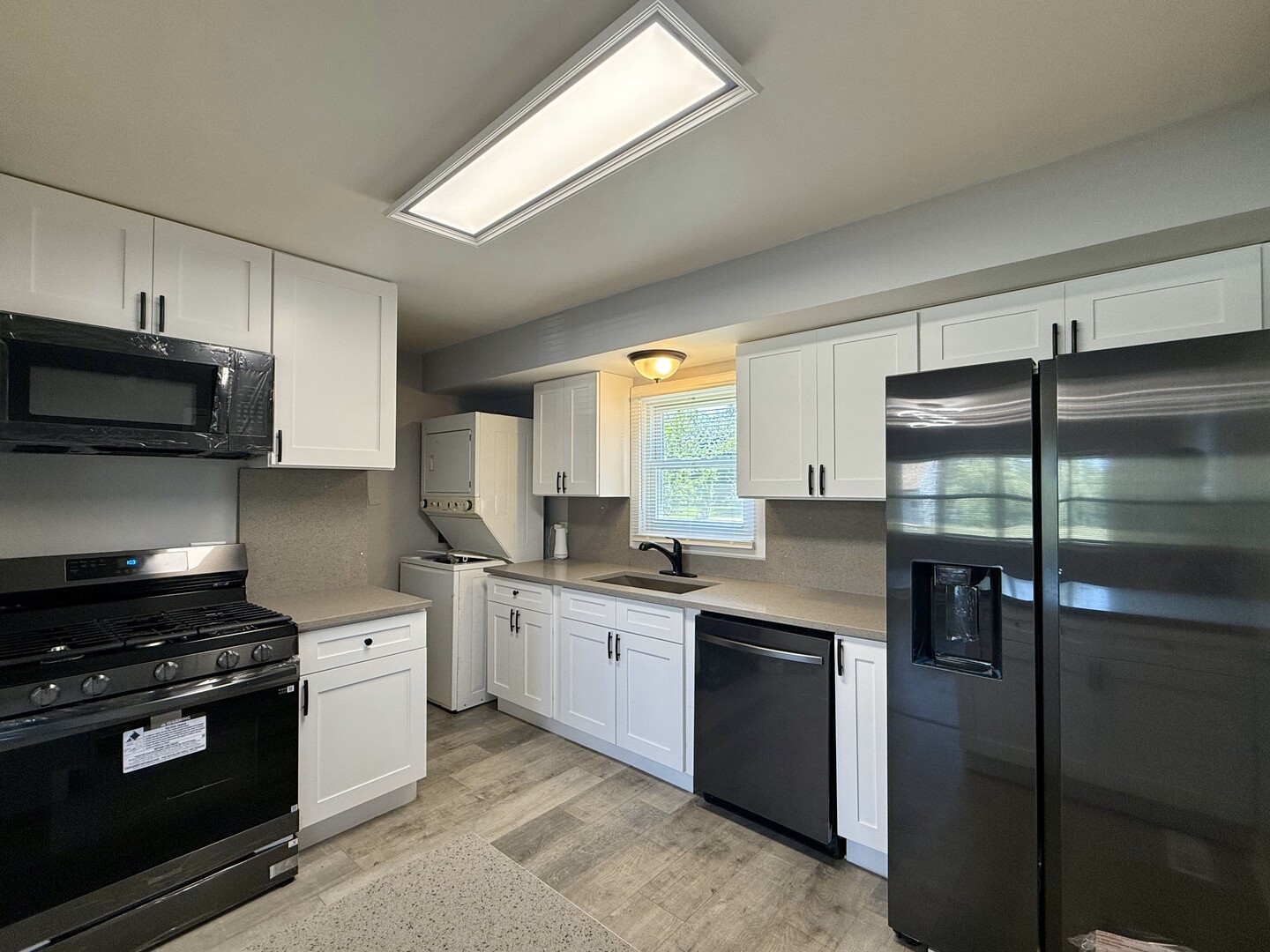 263 Allegheny Street Park Forest, IL 60466 - Photo 4 of 15 a kitchen with stainless steel appliances a refrigerator a stove a sink and a microwave