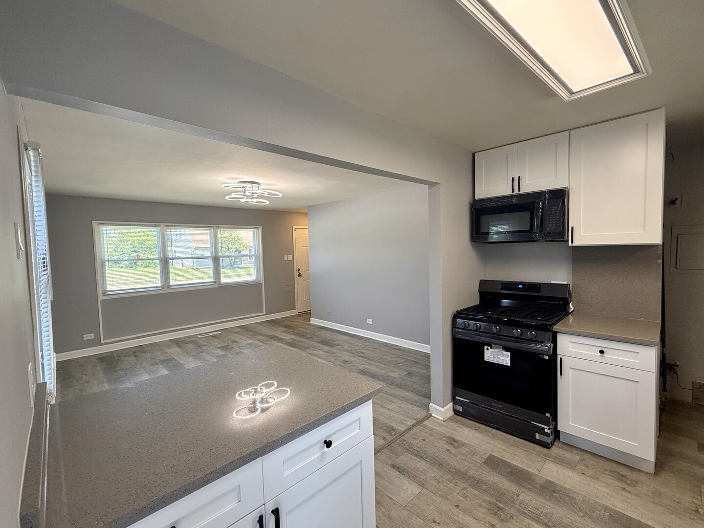 263 Allegheny Street Park Forest, IL 60466 - Photo 5 of 15 a kitchen with granite countertop a stove and a refrigerator