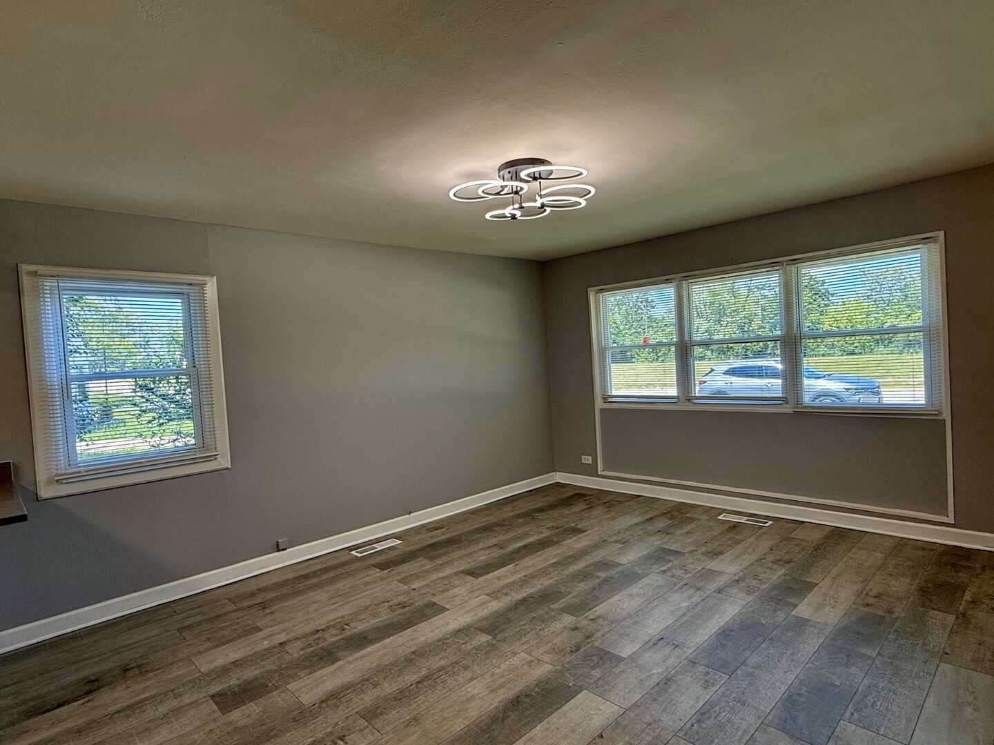 263 Allegheny Street Park Forest, IL 60466 - Photo 7 of 15 an empty room with wooden floor and windows