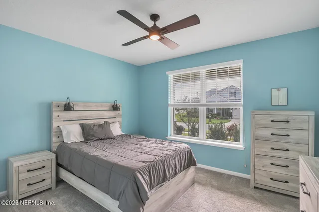 a bedroom with a large bed and a large window