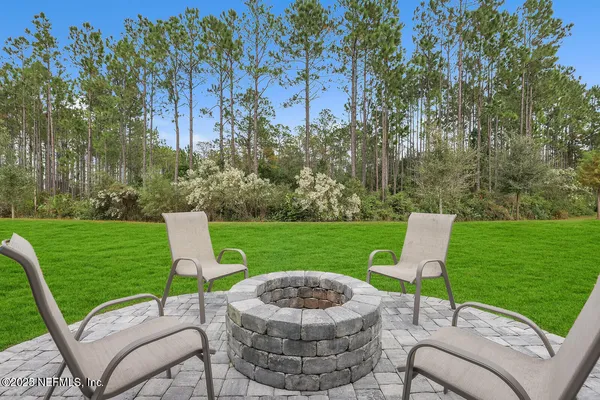 a view of a table and chairs in the garden