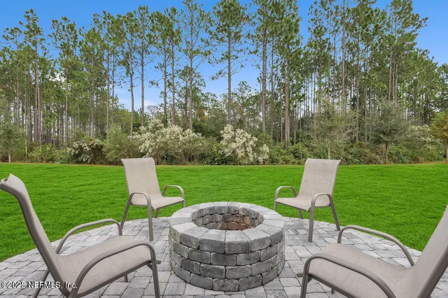 a view of a table and chairs in the garden