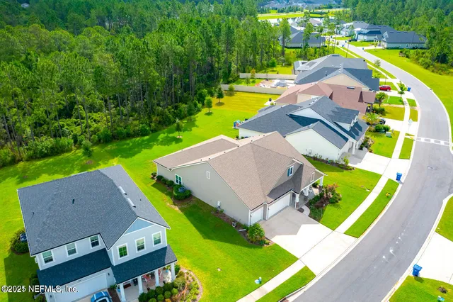 an aerial view of a house with swimming pool and garden view