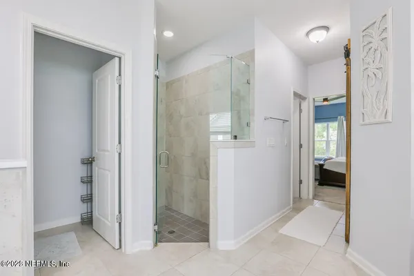 a bathroom with a shower and a glass door
