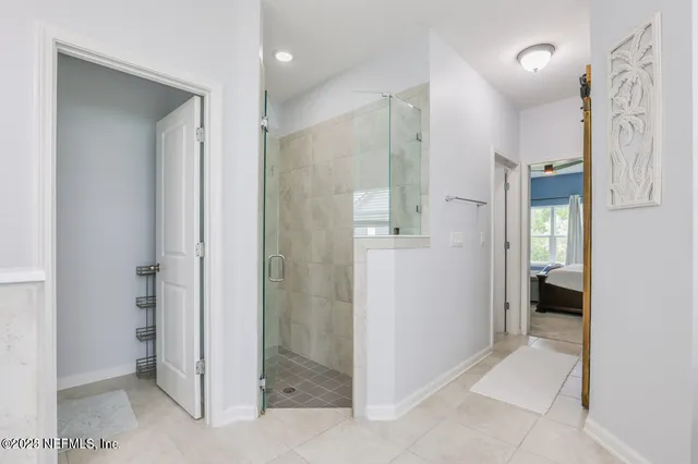 a bathroom with a shower and a glass door