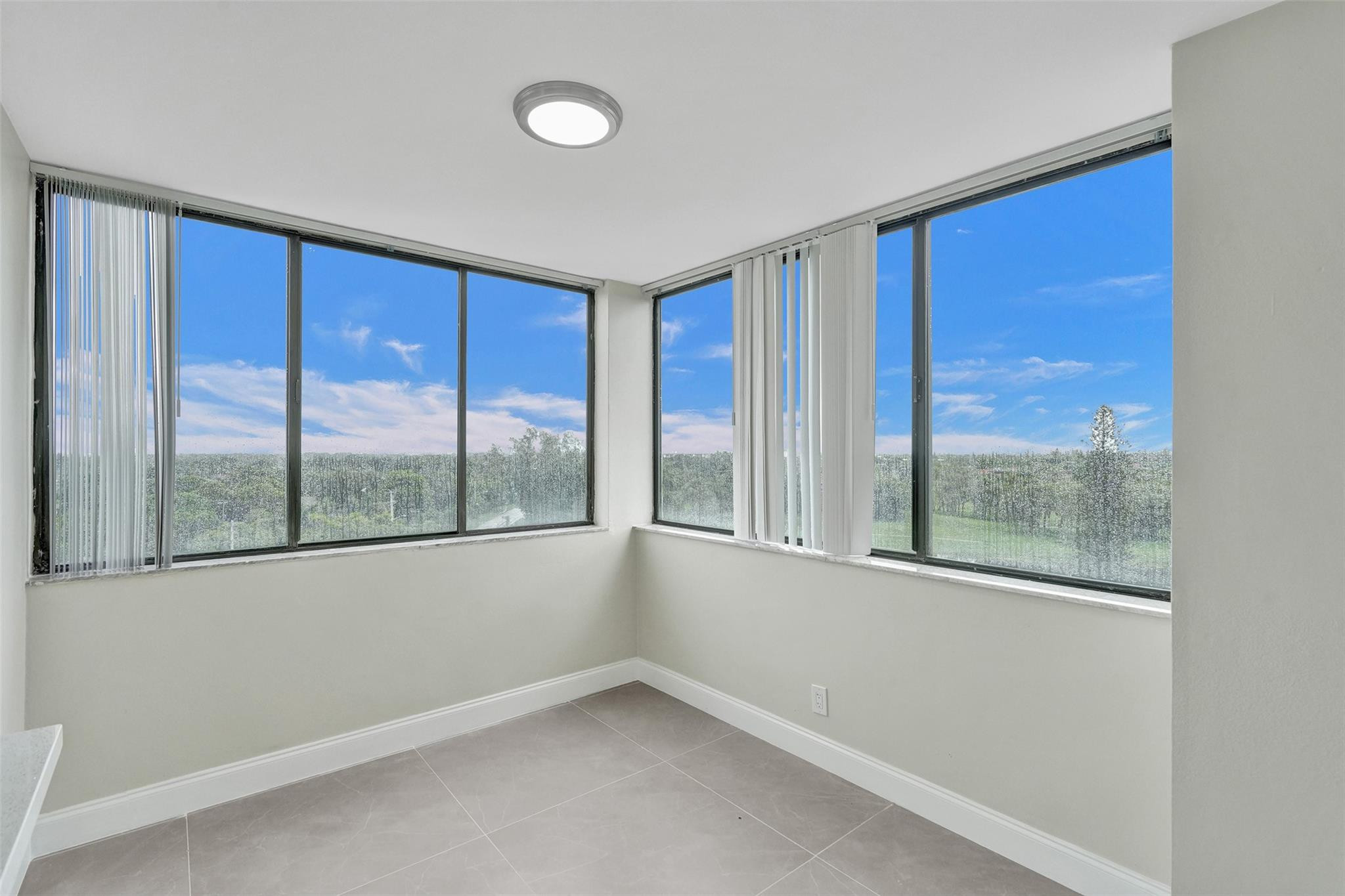 4222 Inverrary Boulevard, Unit 4810 Lauderhill, FL 33319 - Photo 15 of 63 an empty room with wooden floor and windows