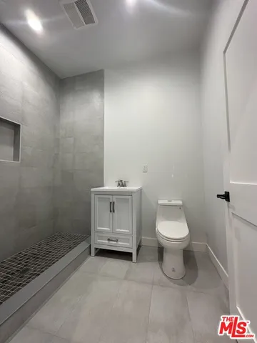 a bathroom with a toilet a sink and shower