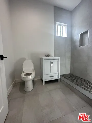 a bathroom with a sink a toilet and a window