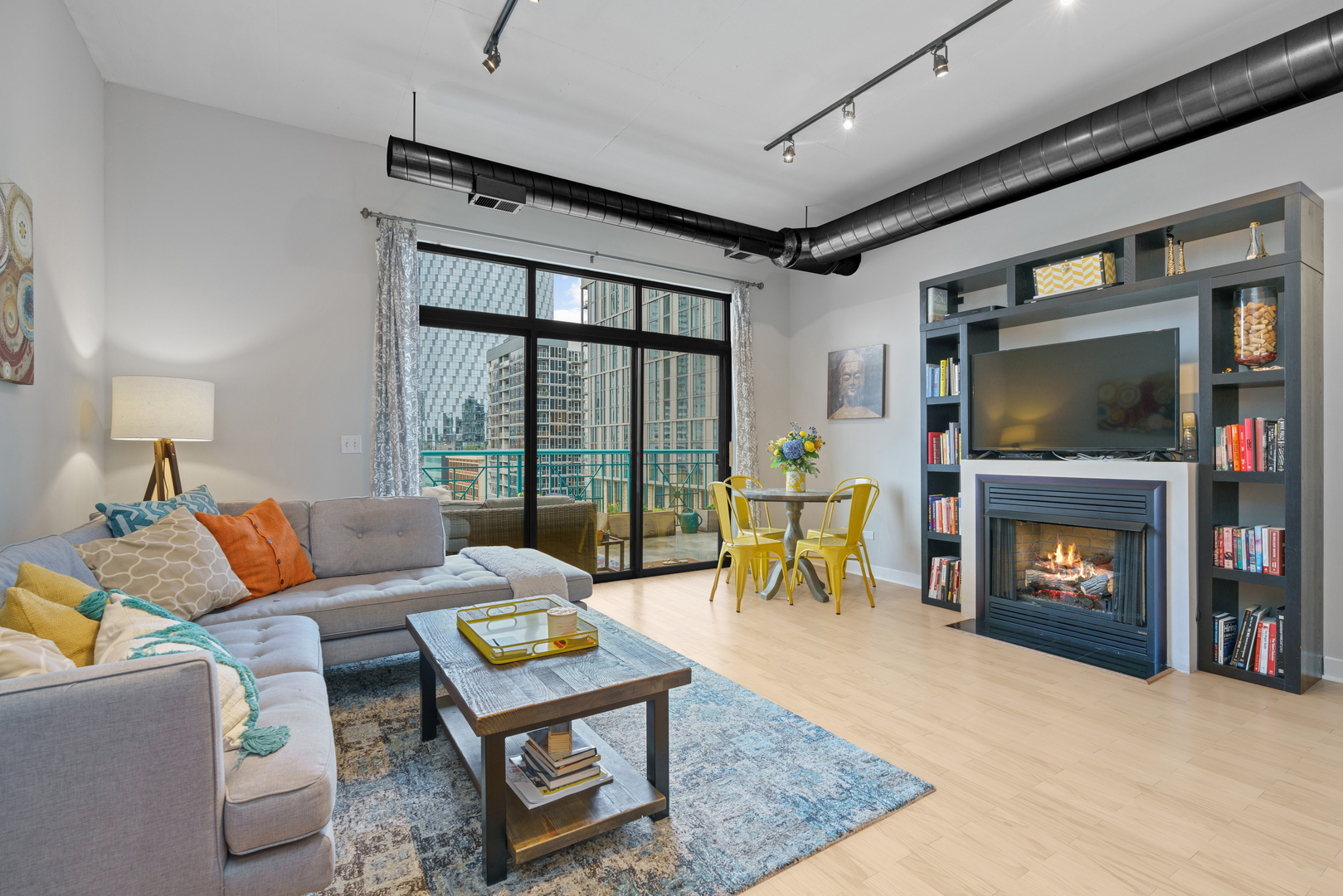 910 West Madison Street, Unit 807 Chicago, IL 60607 - Photo 3 of 21 a living room with furniture a flat screen tv and a fireplace