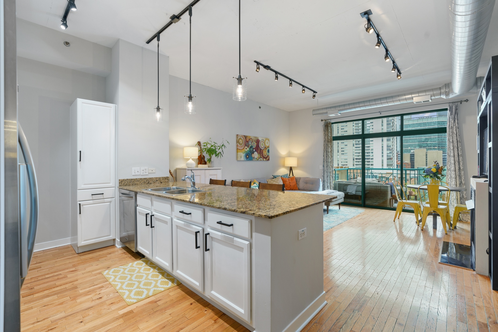 910 West Madison Street, Unit 807 Chicago, IL 60607 - Photo 8 of 21 a kitchen with counter top space and wooden floor