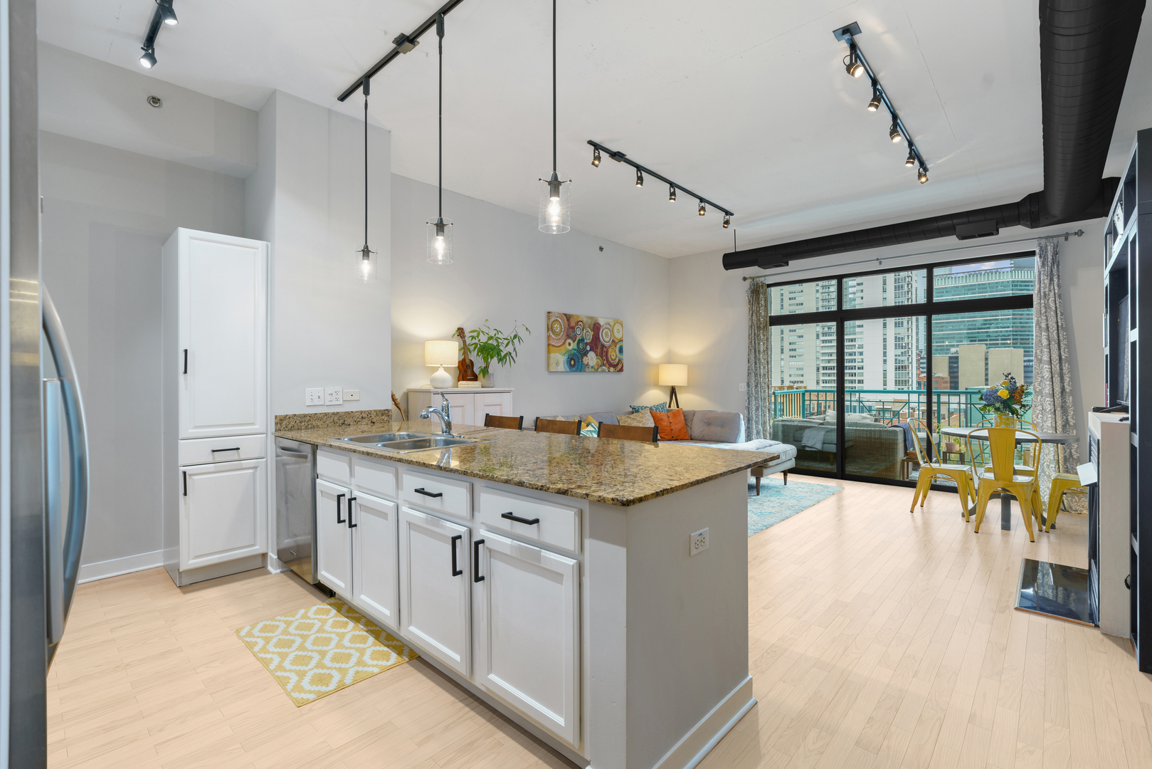 910 West Madison Street, Unit 807 Chicago, IL 60607 - Photo 9 of 21 a kitchen with stainless steel appliances granite countertop a sink and a refrigerator