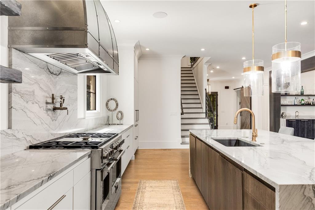 306 Pinecrest Road Northeast Atlanta, GA 30342 - Photo 14 of 67 a kitchen with stainless steel appliances granite countertop a sink and a stove