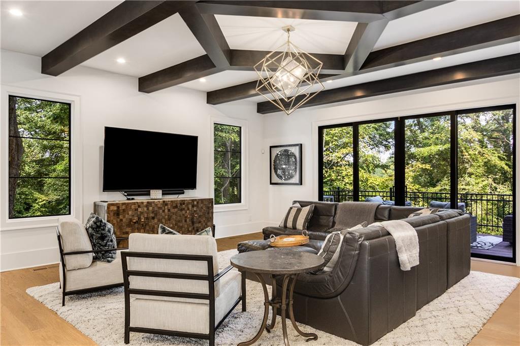 306 Pinecrest Road Northeast Atlanta, GA 30342 - Photo 19 of 67 a living room with furniture a flat screen tv and a large window