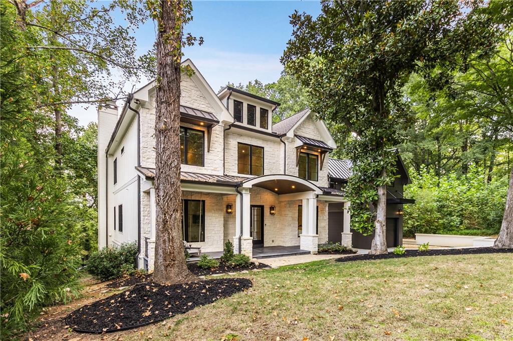 306 Pinecrest Road Northeast Atlanta, GA 30342 - Photo 2 of 67 a front view of a house with a yard