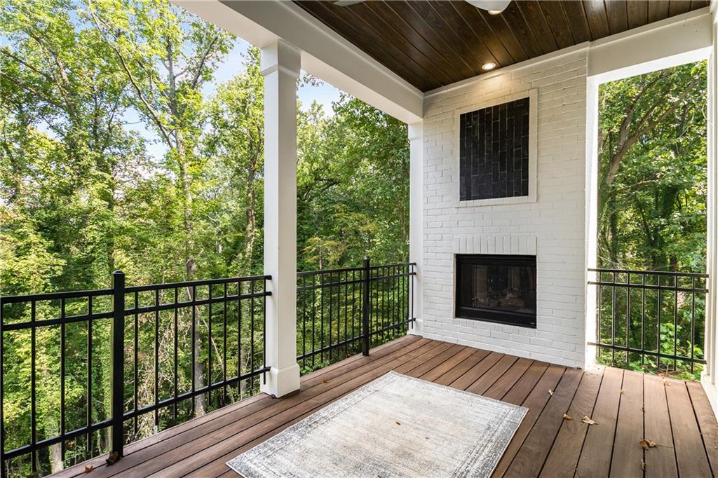 306 Pinecrest Road Northeast Atlanta, GA 30342 - Photo 35 of 67 a view of a balcony with a fireplace and wooden floor