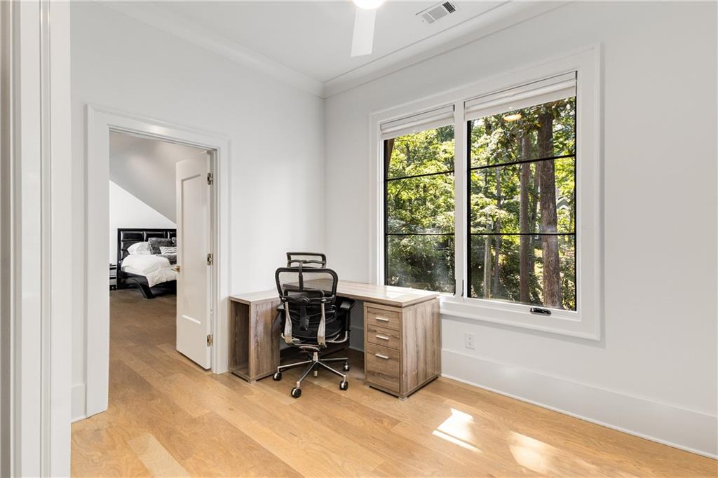 306 Pinecrest Road Northeast Atlanta, GA 30342 - Photo 38 of 67 a view of a workspace with furniture and a window