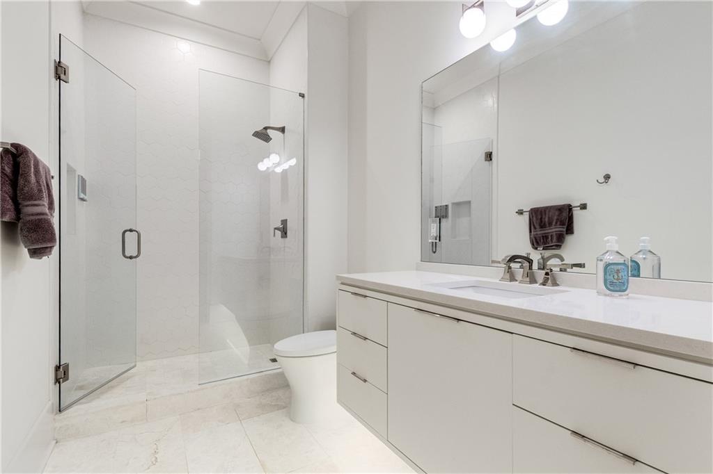 306 Pinecrest Road Northeast Atlanta, GA 30342 - Photo 41 of 67 a bathroom with a sink a toilet and shower