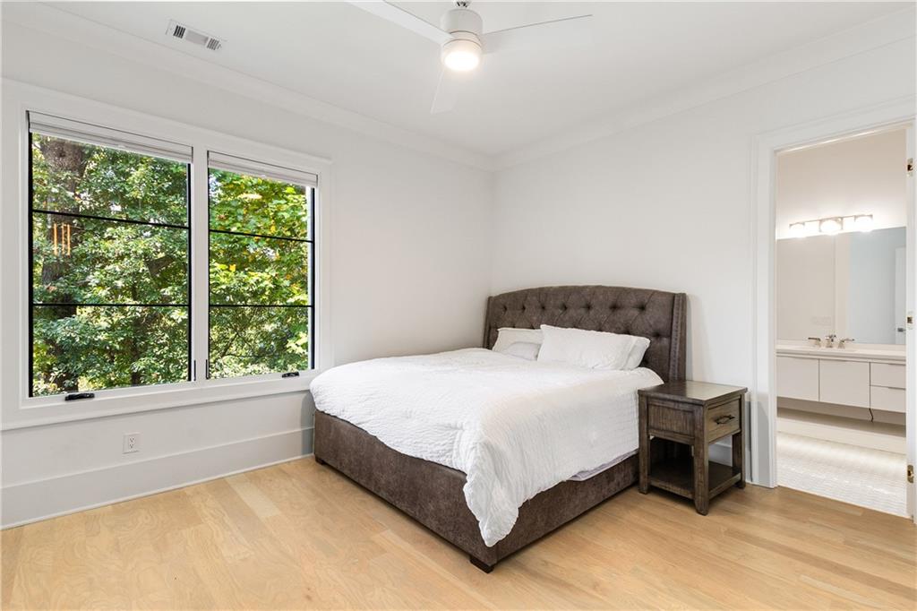 306 Pinecrest Road Northeast Atlanta, GA 30342 - Photo 42 of 67 a bedroom with a bed lamp and window