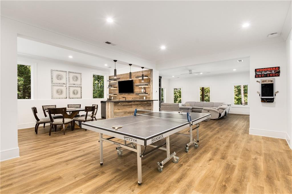 306 Pinecrest Road Northeast Atlanta, GA 30342 - Photo 45 of 67 a kitchen with stainless steel appliances a living room dining table chairs and flat screen tv