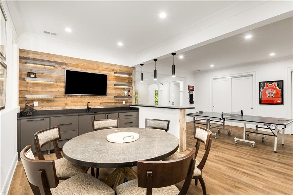 306 Pinecrest Road Northeast Atlanta, GA 30342 - Photo 48 of 67 a kitchen with stainless steel appliances kitchen island granite countertop a sink a stove a dining table and chairs