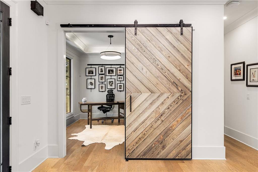 306 Pinecrest Road Northeast Atlanta, GA 30342 - Photo 5 of 67 a view of a bedroom with wooden floor and furniture