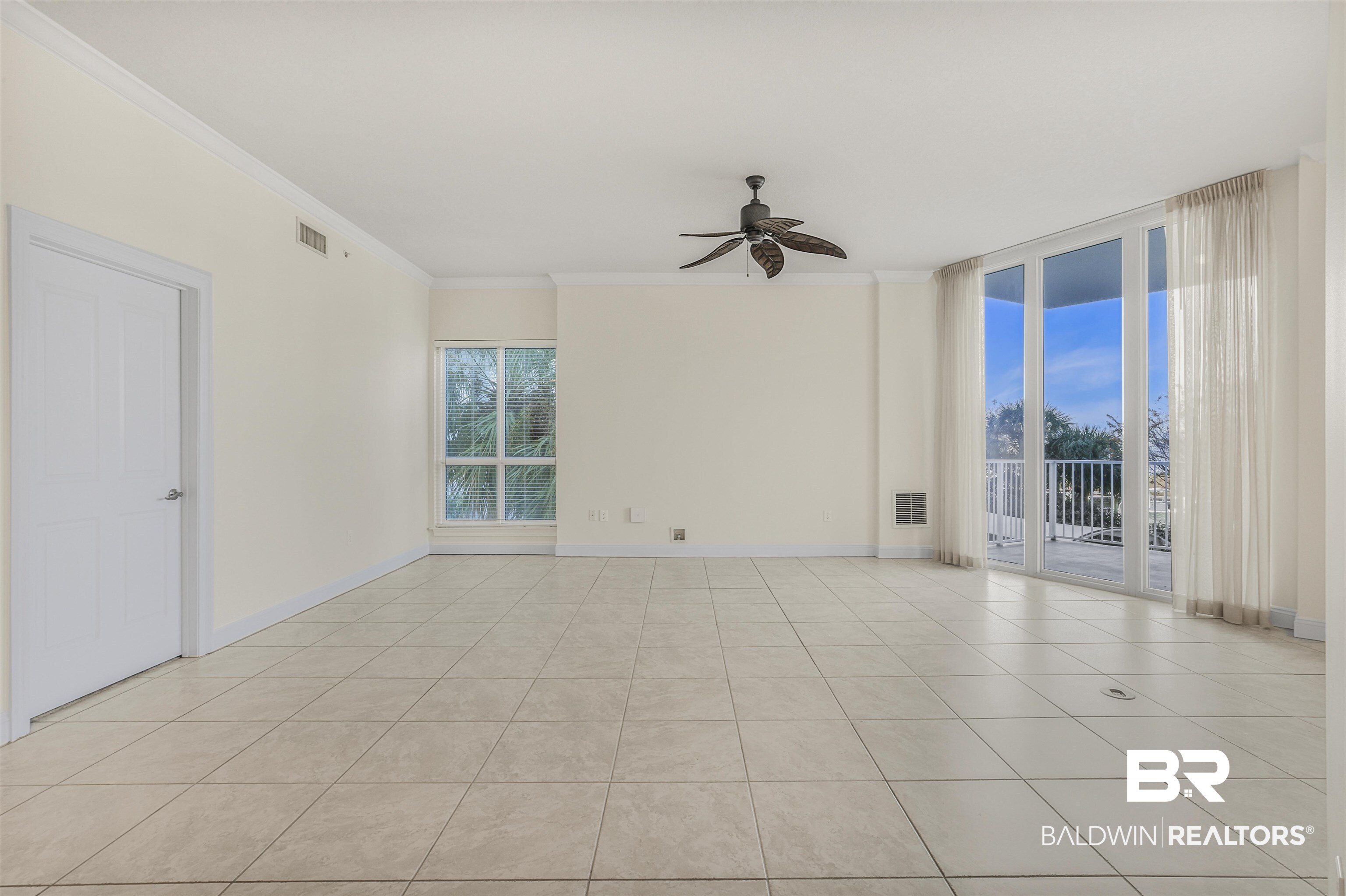 28250 Canal Road, Unit 106 Orange Beach, AL 36561 - Photo 6 of 50 Unfurnished room with ceiling fan, floor to ceiling windows, ornamental molding, and light tile patterned flooring