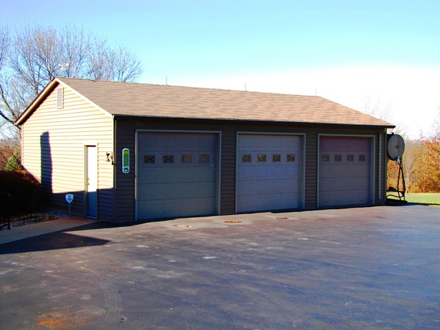 170 Montgomery Road Montgomery, IL 60538 - Photo 21 of 25 a front view of a house with a garage