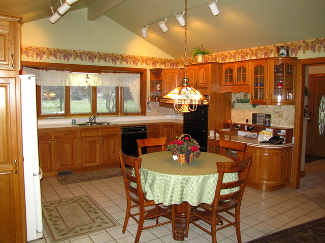 170 Montgomery Road Montgomery, IL 60538 - Photo 4 of 25 a kitchen with a table and chairs in it
