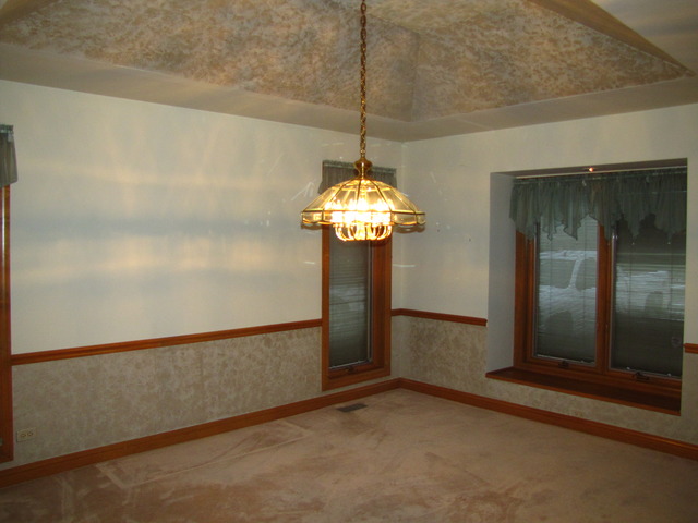 170 Montgomery Road Montgomery, IL 60538 - Photo 10 of 25 a view of a chandelier fan and refrigerator in a room