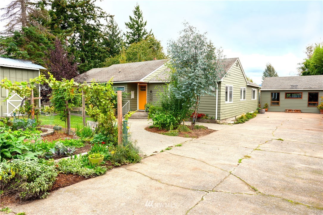 17932 Dunbar Road Mount Vernon, WA 98273 - Photo 1 of 39 a front view of a house with a yard and potted plants