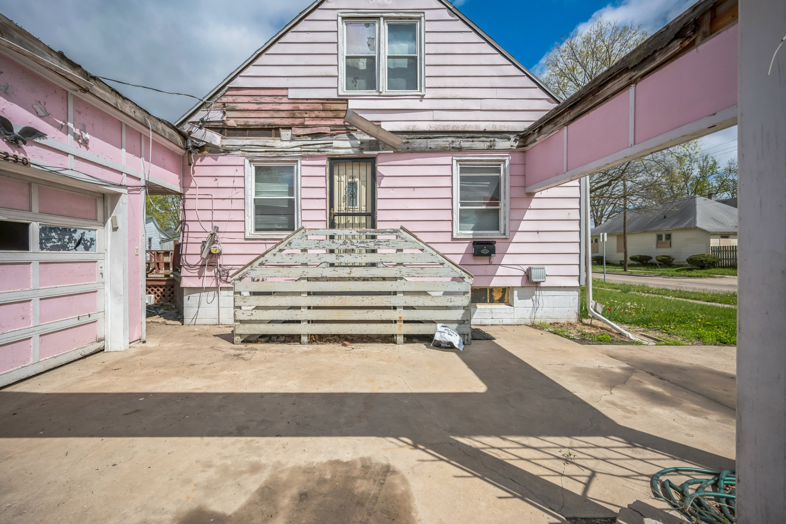230 West Garfield Avenue Decatur, IL 62526 - Photo 12 of 34 a front view of a house with a yard and garage