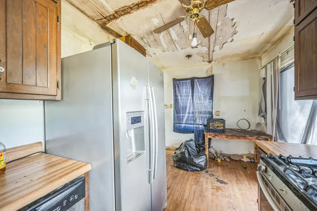 a kitchen with a sink and wooden floor