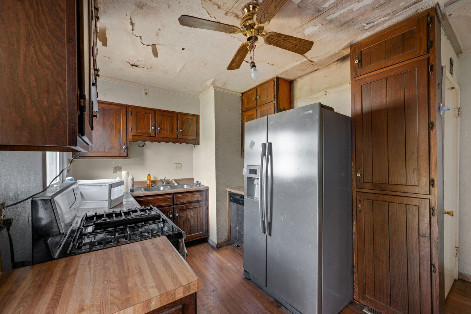 230 West Garfield Avenue Decatur, IL 62526 - Photo 17 of 34 a kitchen with stainless steel appliances granite countertop a refrigerator a sink dishwasher a stove and a refrigerator with wooden floor