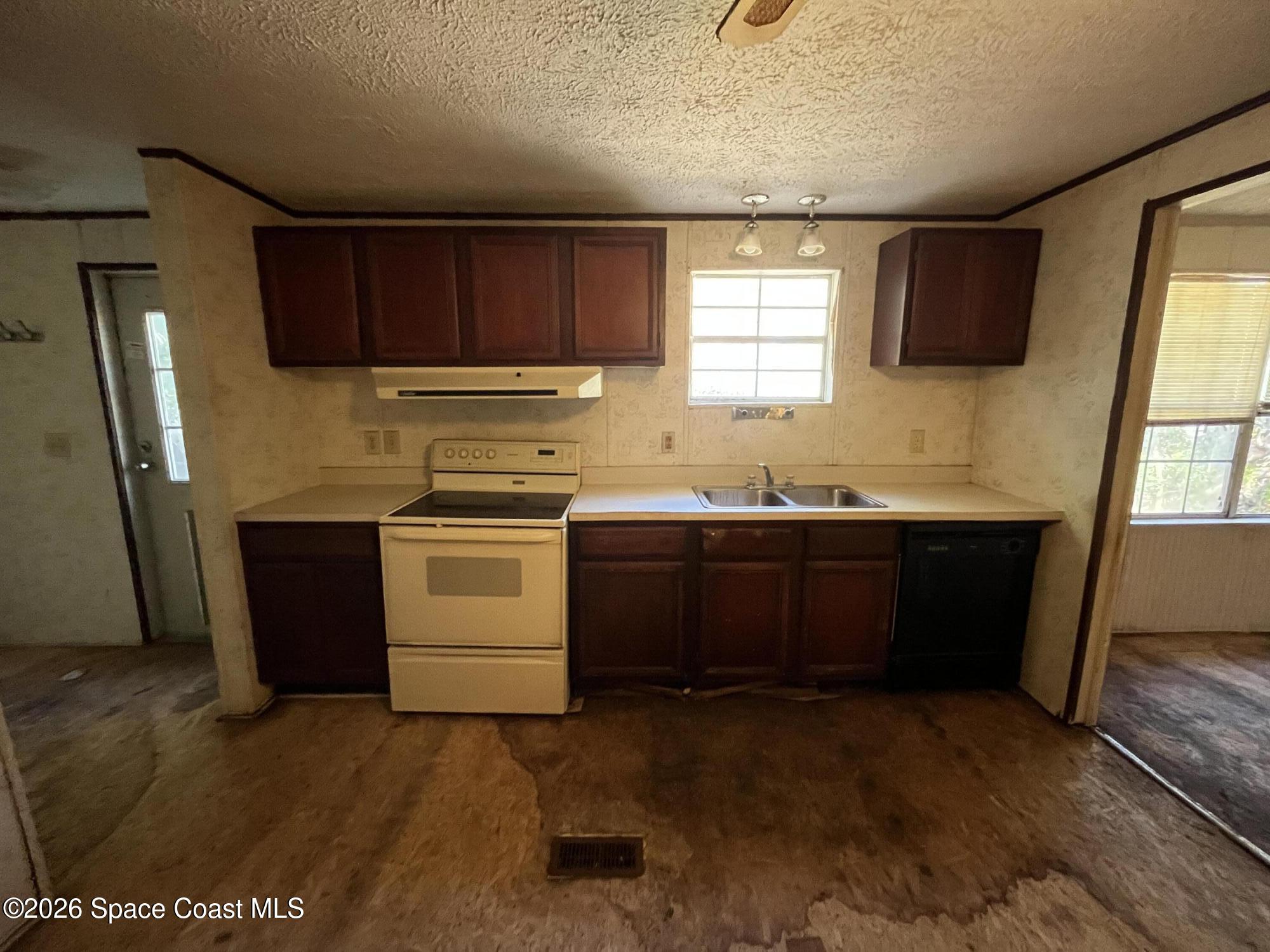 180 Rita Boulevard Melbourne Beach, FL 32951 - Photo 5 of 10 a kitchen with a sink stove and refrigerator
