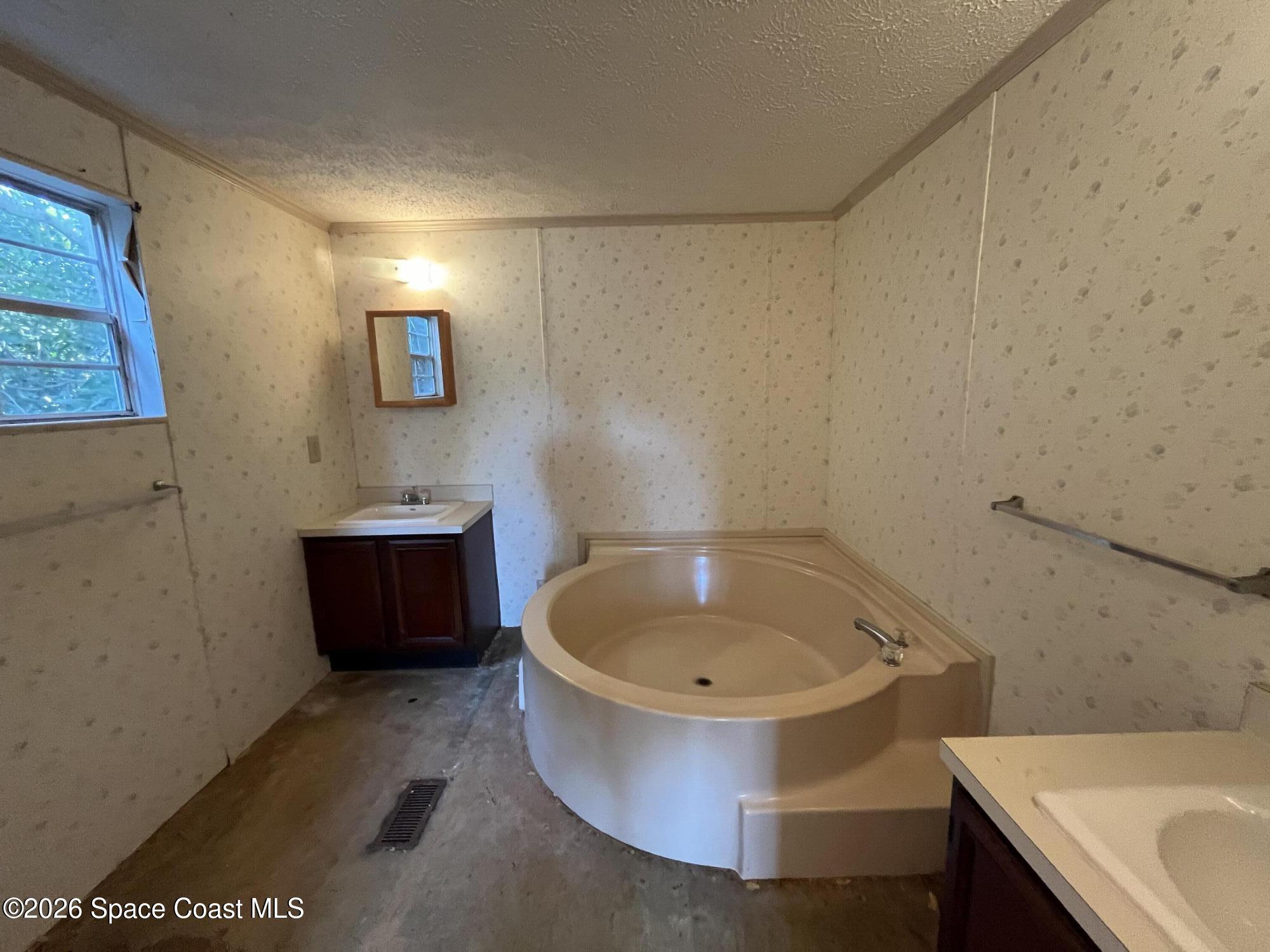 180 Rita Boulevard Melbourne Beach, FL 32951 - Photo 7 of 10 a bathroom with a tub a sink and a window