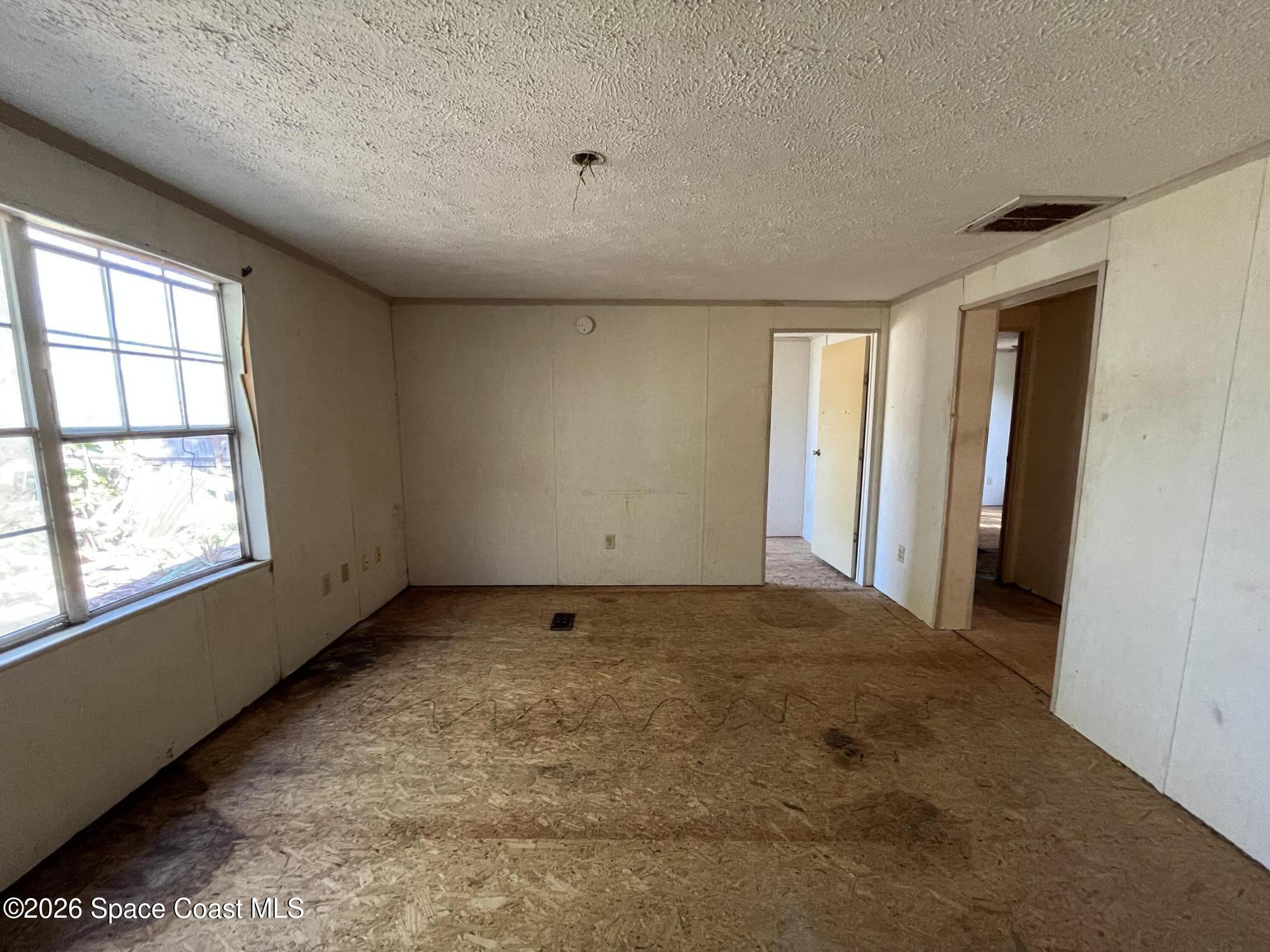 180 Rita Boulevard Melbourne Beach, FL 32951 - Photo 8 of 10 an empty room with windows