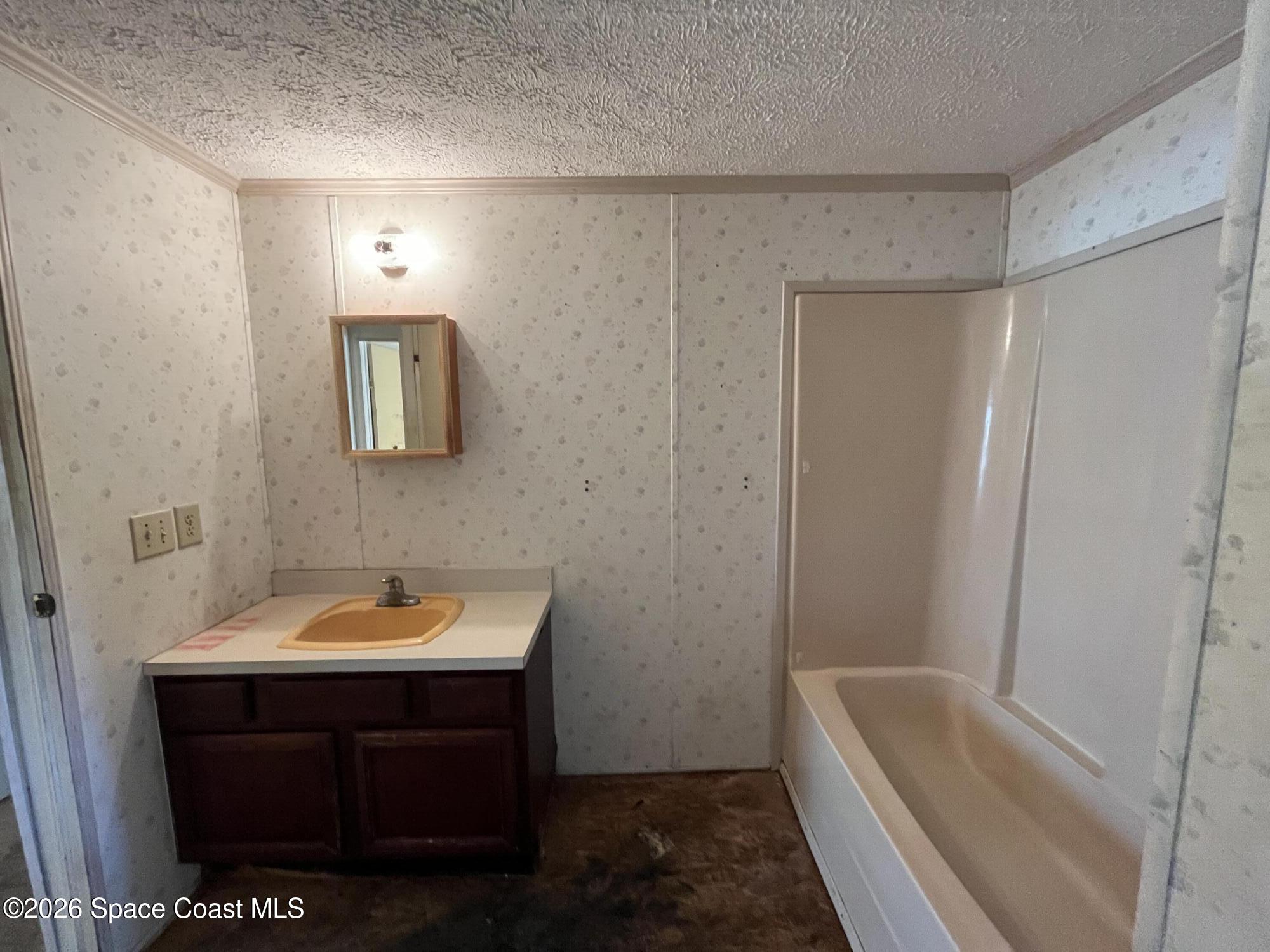 180 Rita Boulevard Melbourne Beach, FL 32951 - Photo 10 of 10 a bathroom with a sink a toilet a tub and shower