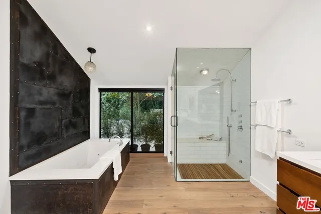a bathroom with a bathtub and a shower