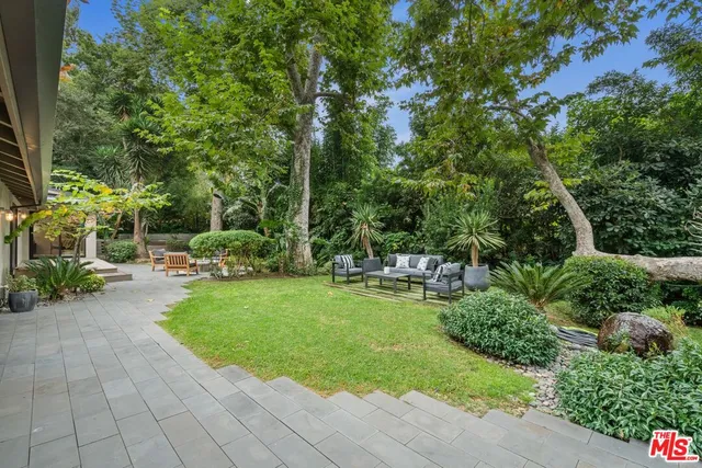 a view of a backyard with sitting area